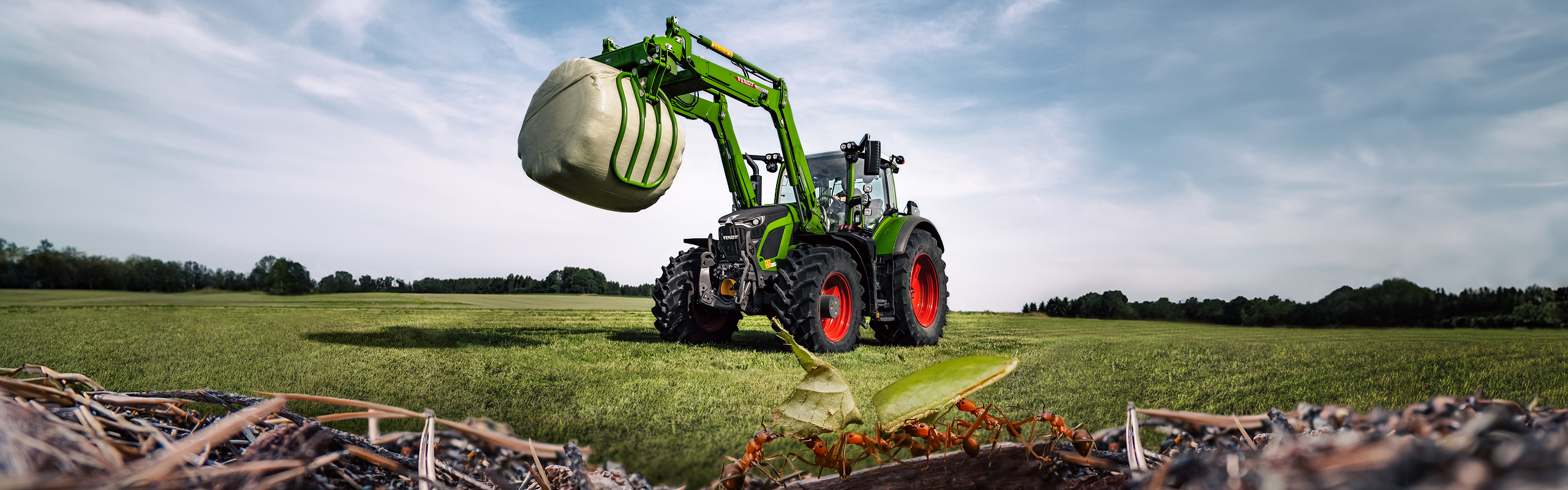 600 Vario with front loader on a field with ants in the foreground
